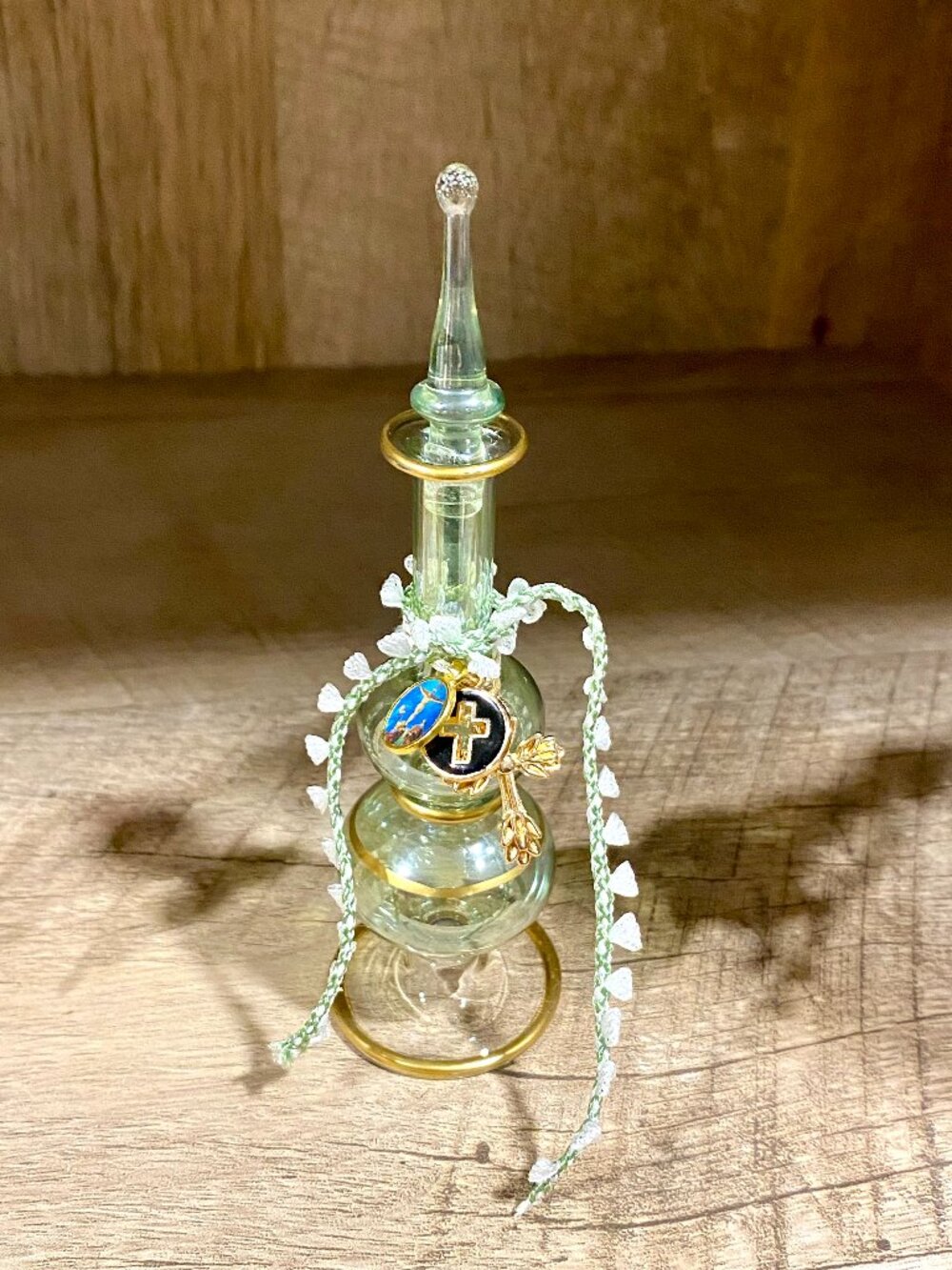 Holy water glass vessel with religious charms